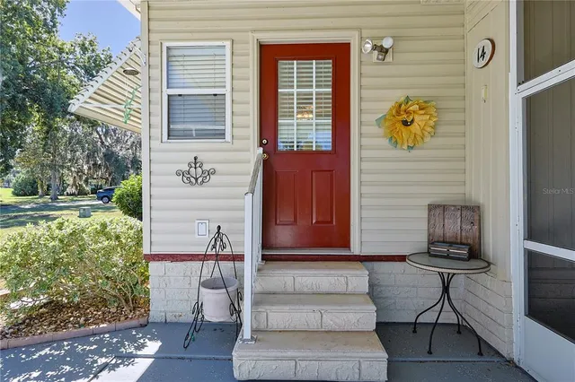 a kitchen with stainless steel appliances a stove top oven a refrigerator a sink and dishwasher with wooden floor