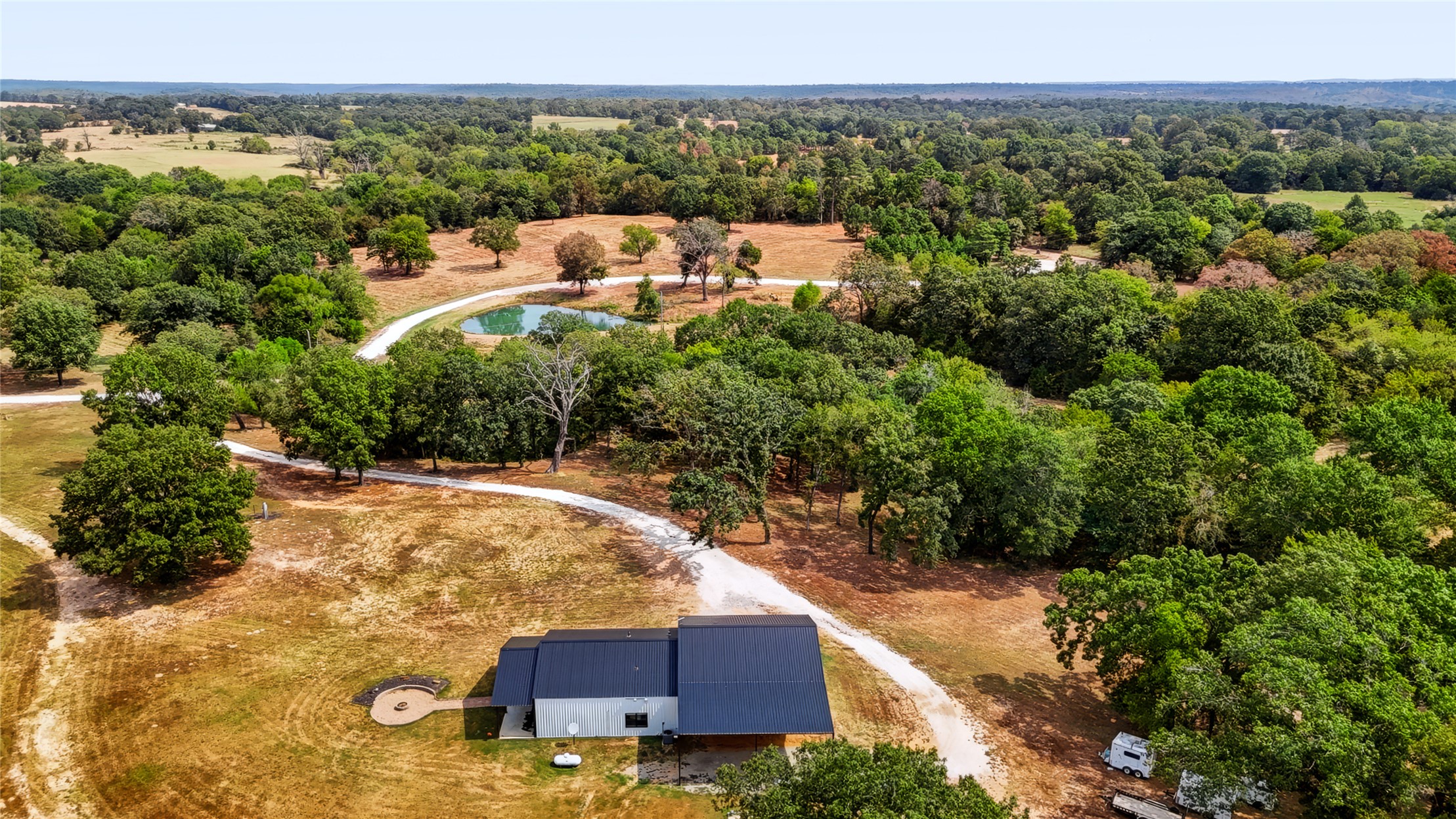 3607 South Half Bank Road Atoka, OK 74525 - Photo 57 of 82 Expansive acreage with a contemporary style residence, gravel driveway, and a private pond