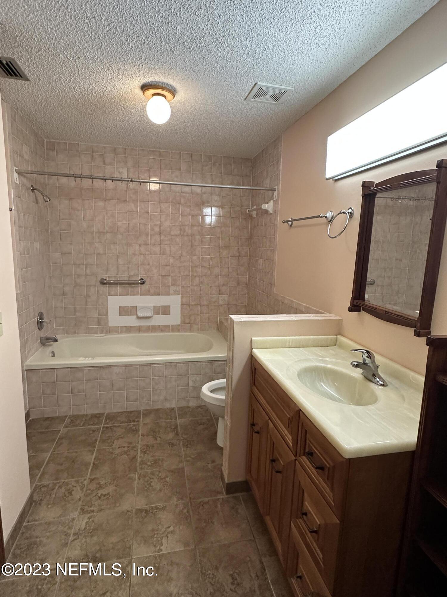 2797 Kings Road St. Augustine, FL 32086 - Photo 11 of 24 a bathroom with a sink a toilet and shower