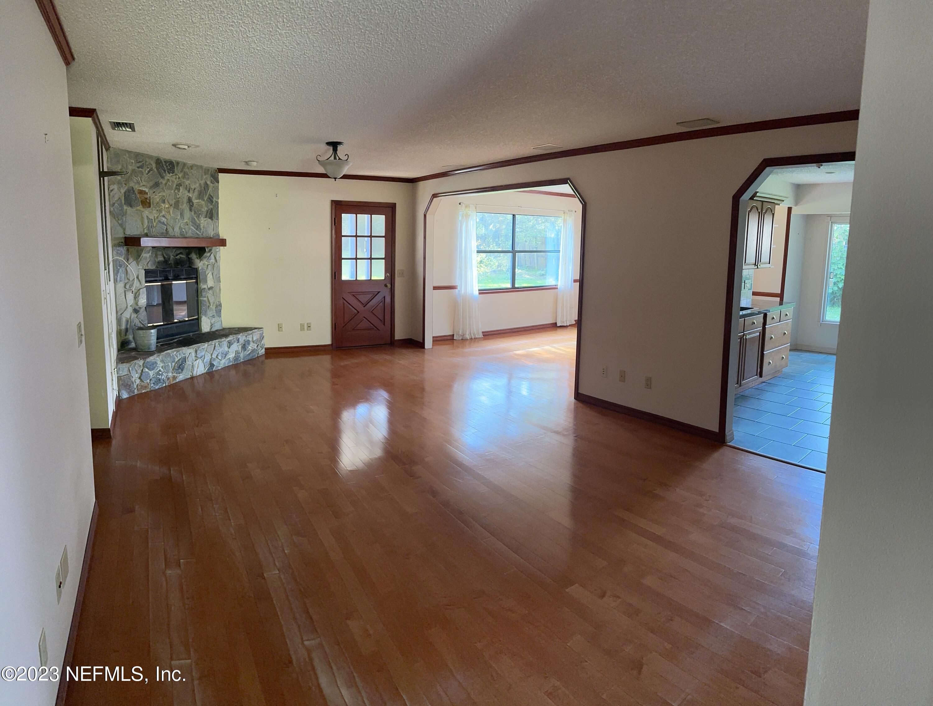 2797 Kings Road St. Augustine, FL 32086 - Photo 4 of 24 a view of a big room with wooden floor and windows