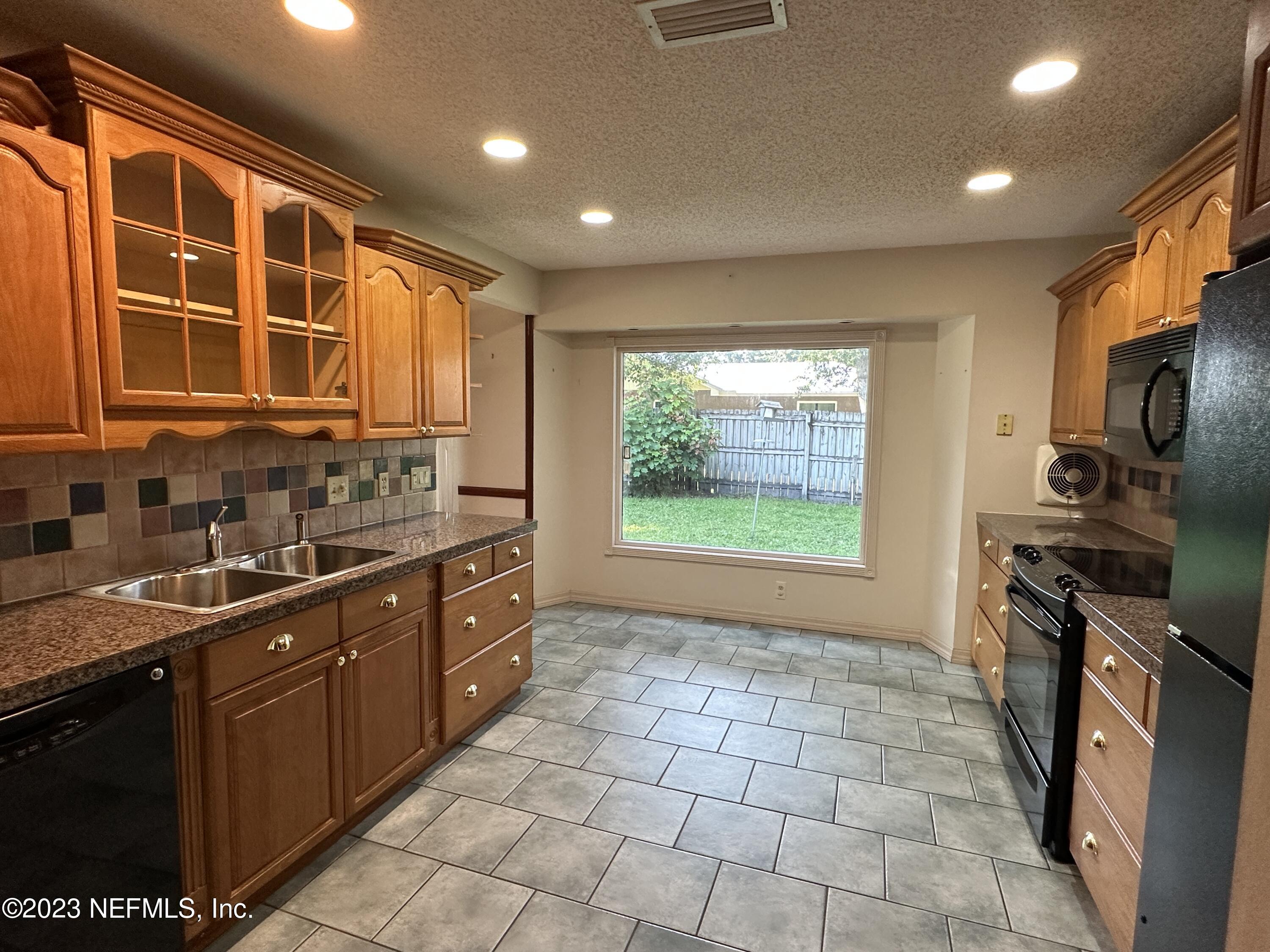 2797 Kings Road St. Augustine, FL 32086 - Photo 5 of 24 a kitchen with stainless steel appliances granite countertop a sink stove and cabinets