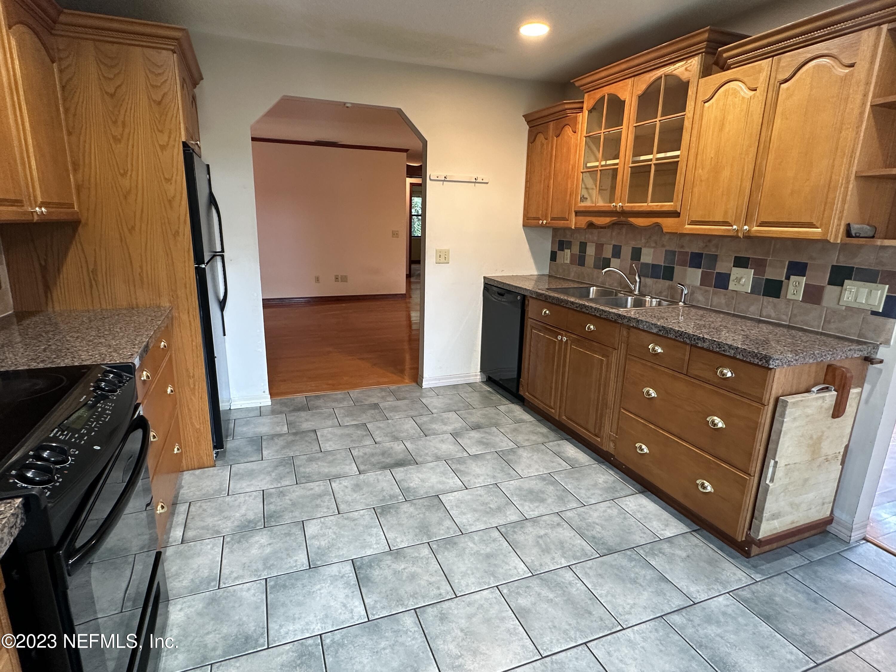 2797 Kings Road St. Augustine, FL 32086 - Photo 6 of 24 a kitchen with stainless steel appliances granite countertop a stove a sink and a microwave