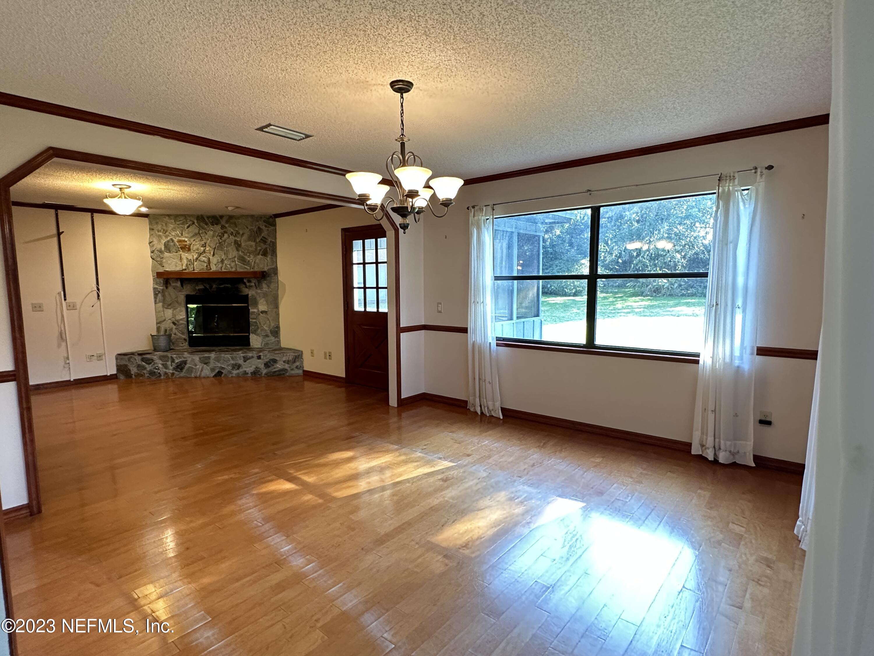 2797 Kings Road St. Augustine, FL 32086 - Photo 8 of 24 a view of a livingroom with a fireplace window and wooden floor