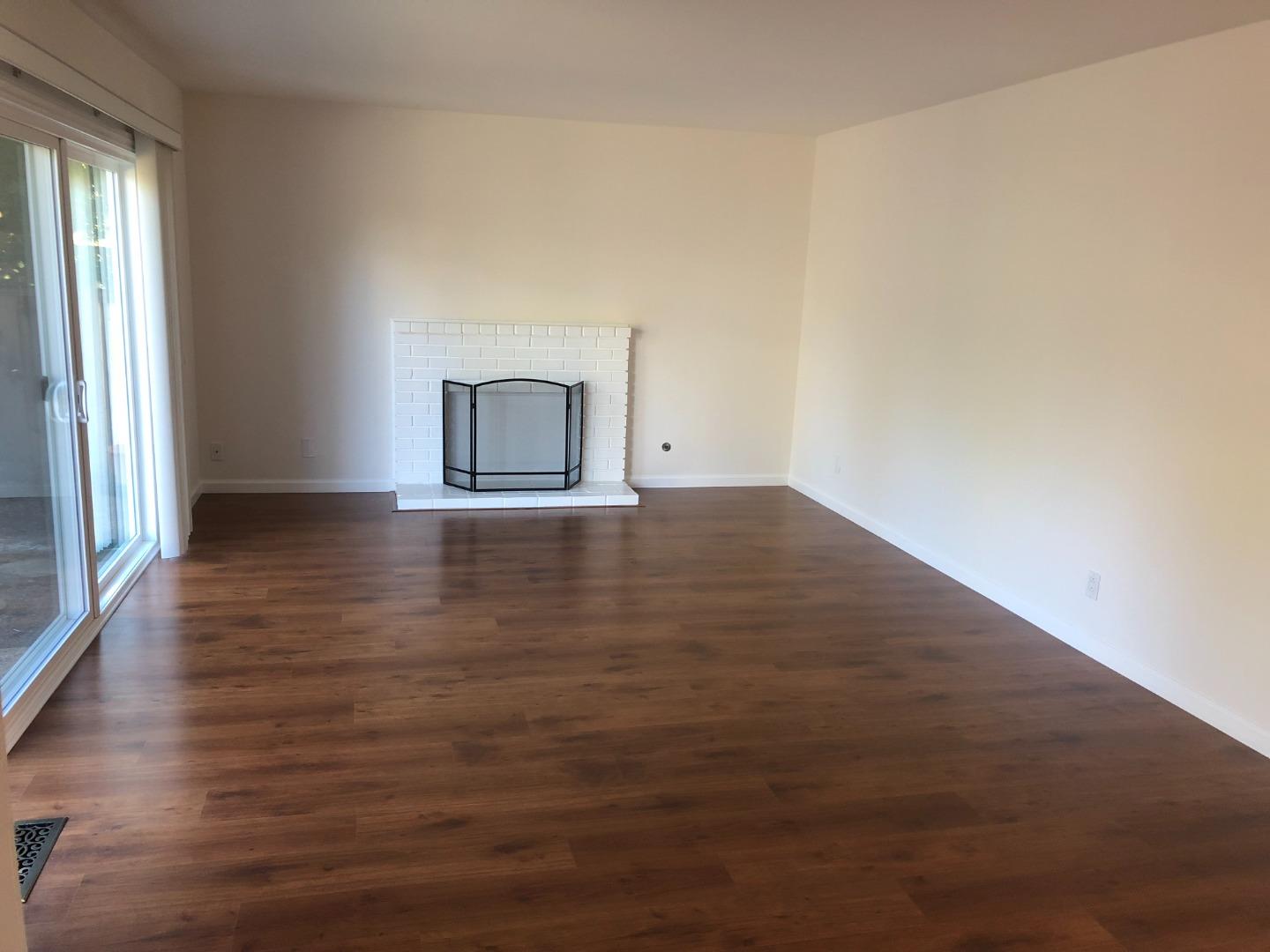 10304 Vista Drive, Unit B Cupertino, CA 95014 - Photo 2 of 16 an empty room with wooden floor and windows