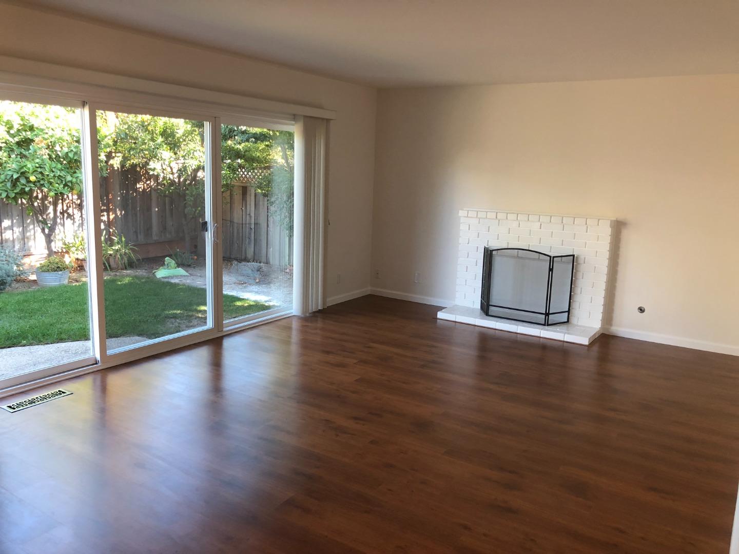 10304 Vista Drive, Unit B Cupertino, CA 95014 - Photo 3 of 16 a view of empty room with wooden floor and fireplace