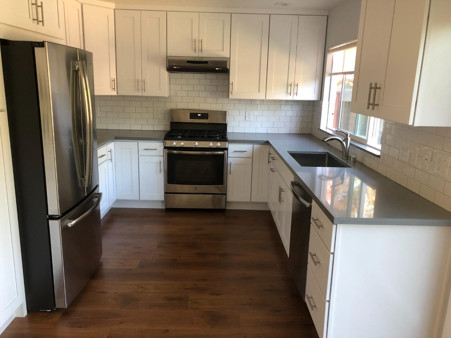 10304 Vista Drive, Unit B Cupertino, CA 95014 - Photo 5 of 16 a kitchen with a refrigerator stove and cabinets