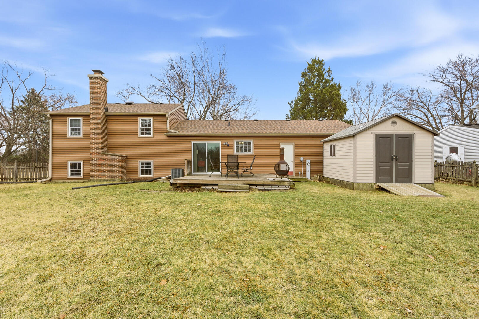 2023 Springside Drive Naperville, IL 60565 - Photo 2 of 16 a view of a yard with a house and a large tree