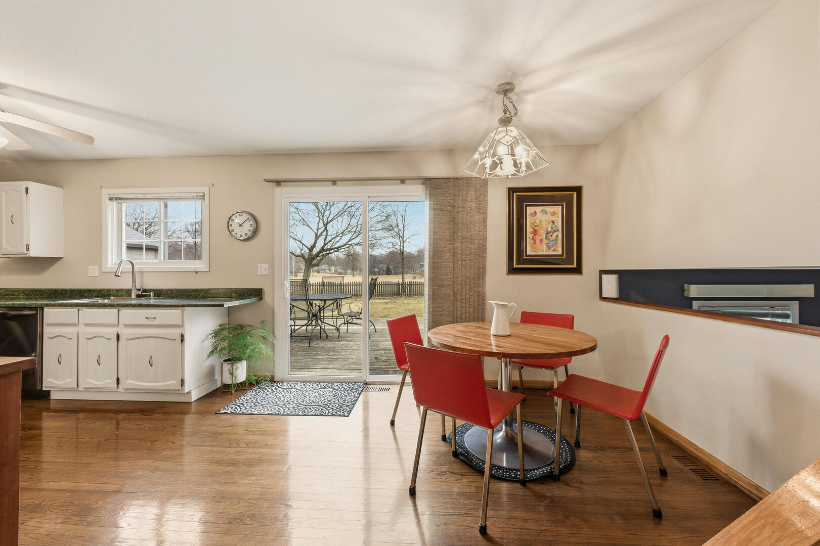2023 Springside Drive Naperville, IL 60565 - Photo 6 of 16 a dining room with wooden floor a chandelier a wooden table and chairs