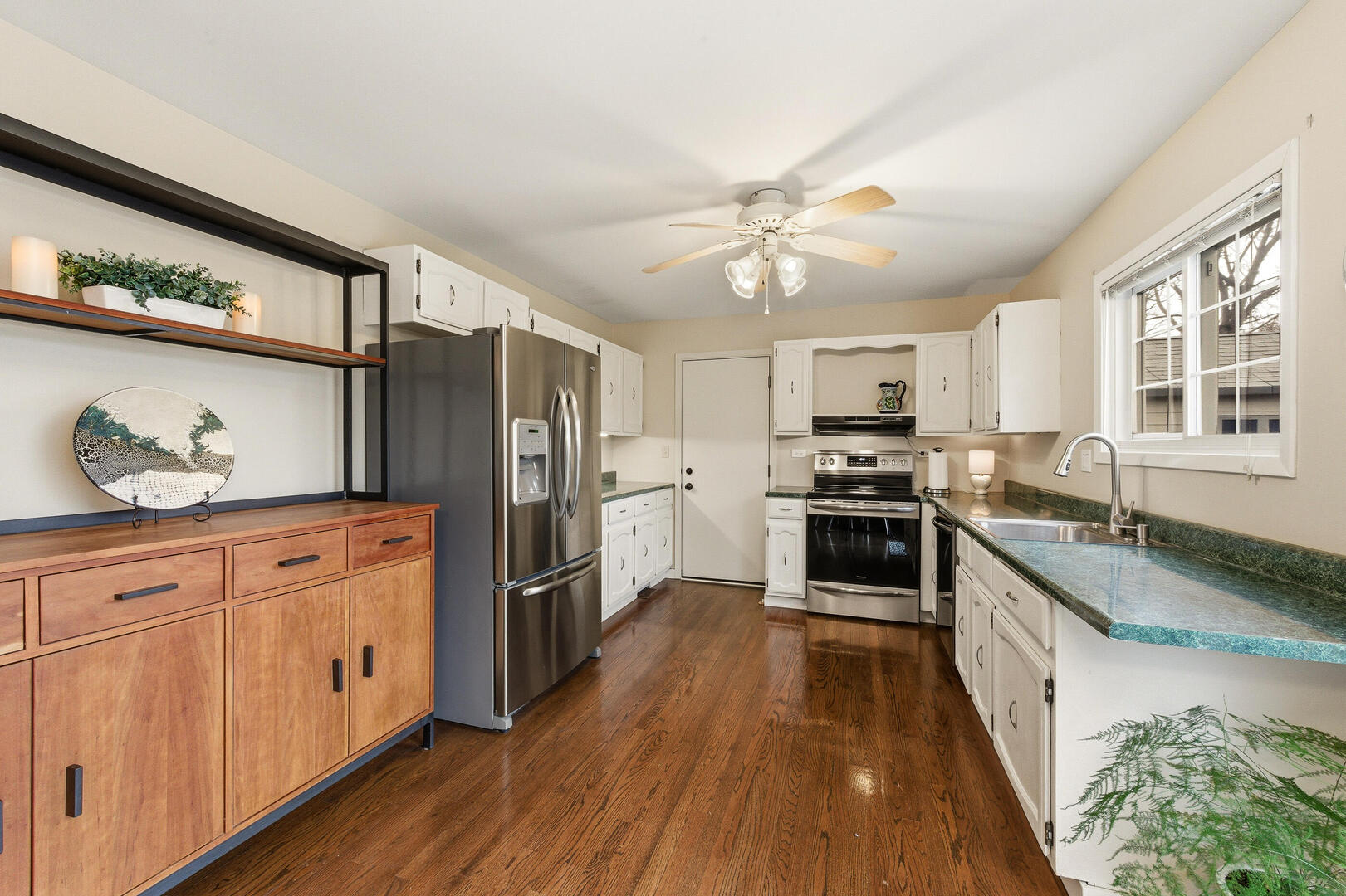 2023 Springside Drive Naperville, IL 60565 - Photo 7 of 16 a kitchen with stainless steel appliances granite countertop a stove cabinets and wooden floor