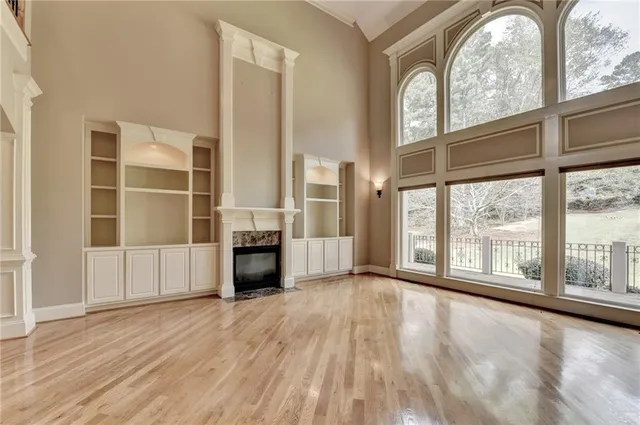 a view of a livingroom with furniture window and wooden floor