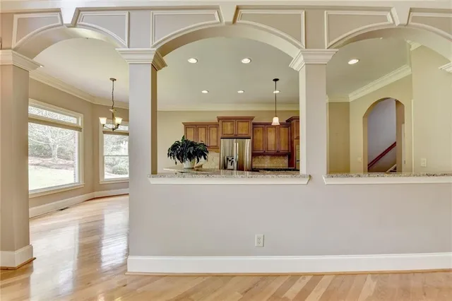 a kitchen with stainless steel appliances granite countertop a refrigerator a stove and a sink