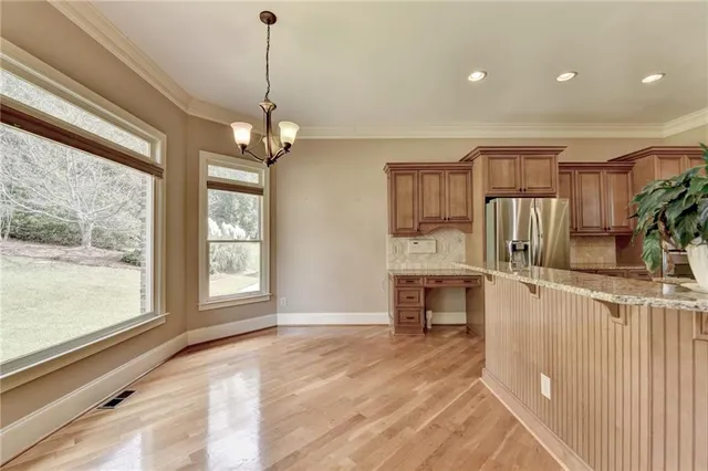 a kitchen with wooden cabinets and a stove top oven
