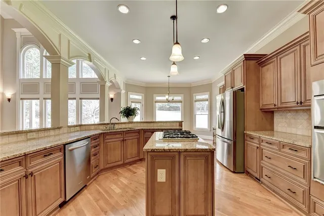 a view of a hallway with wooden floor and stairs