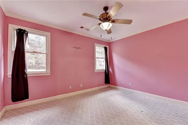 a view of an empty room with a ceiling fan