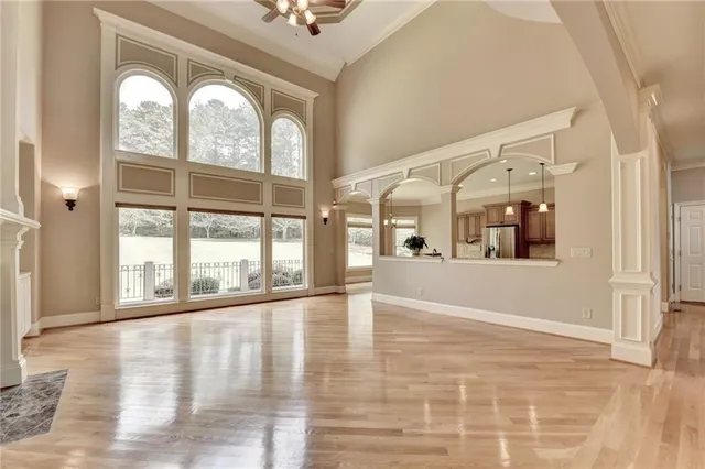 a view of a livingroom with a fireplace closet and windows