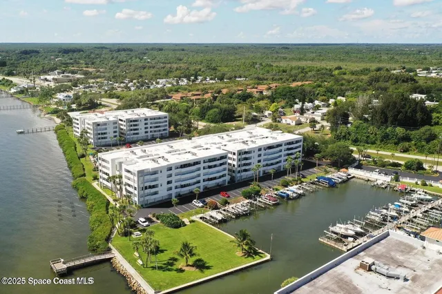 an aerial view of a houses with a lake view