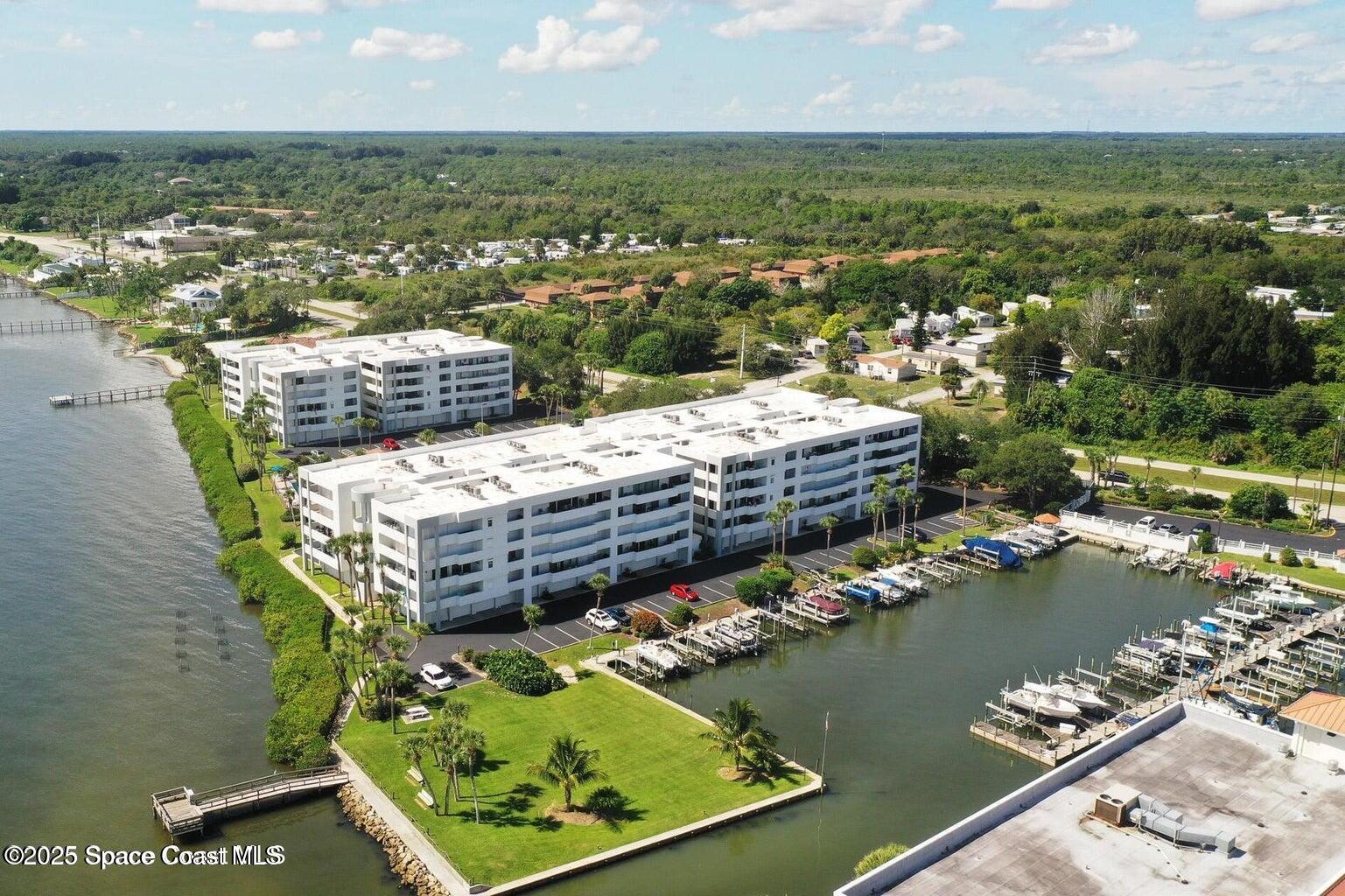 an aerial view of a houses with a lake view