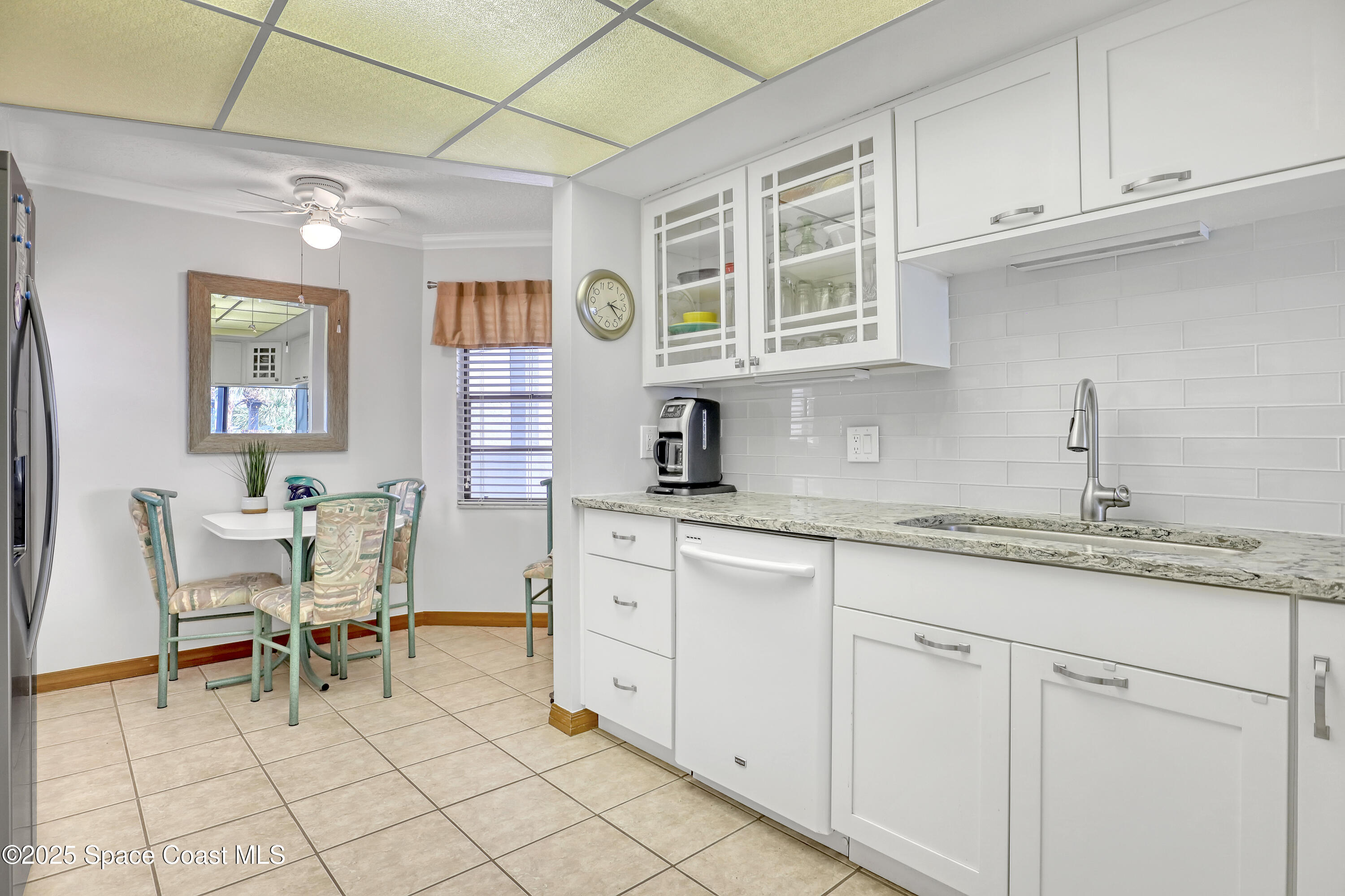 5011 Dixie Highway Northeast, Unit A209 Palm Bay, FL 32905 - Photo 17 of 44 a kitchen with cabinets and chairs