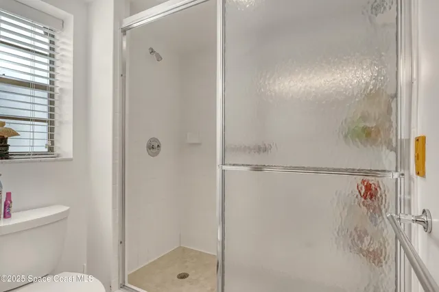 a bedroom with beds and cupboard