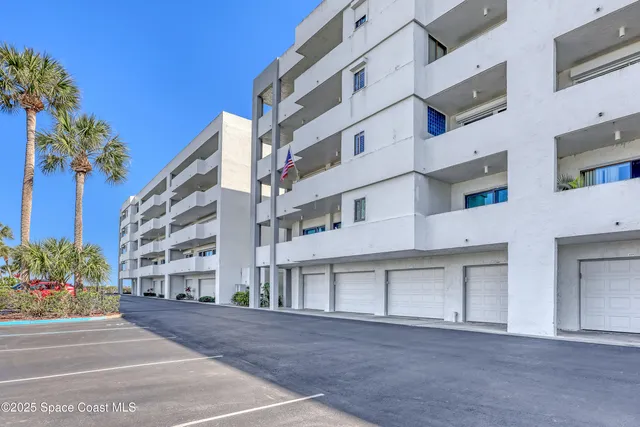 a lobby with furniture and potted plants