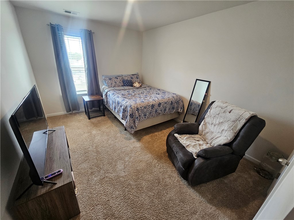 902 Ashwood Lane Easley, SC 29640 - Photo 28 of 39 A well-lit bedroom features plush carpeting and a neutral color palette, ready for personalization.
