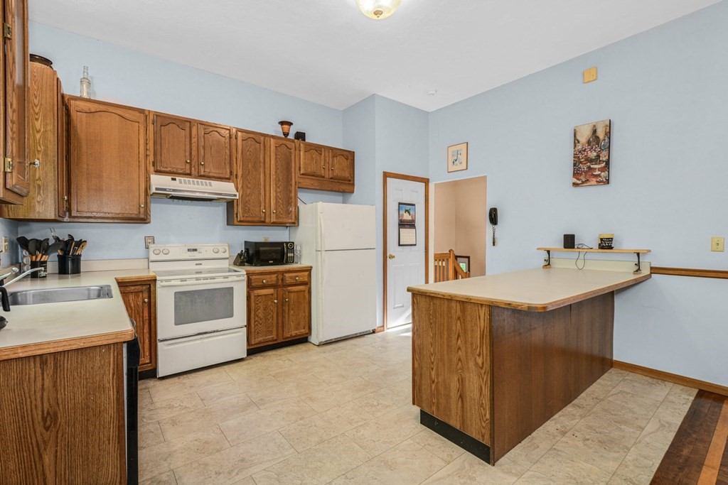 2020 Bay Road Stoughton, MA 02072 - Photo 11 of 38 a kitchen with a sink stove and refrigerator