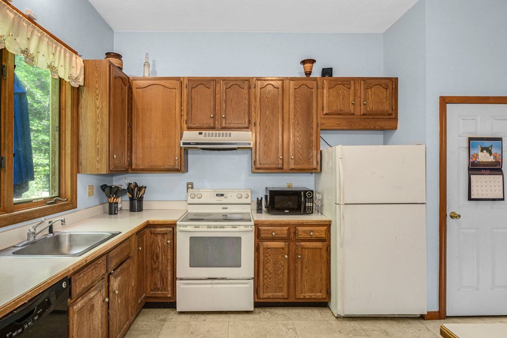 2020 Bay Road Stoughton, MA 02072 - Photo 14 of 38 a kitchen with appliances a sink and cabinets
