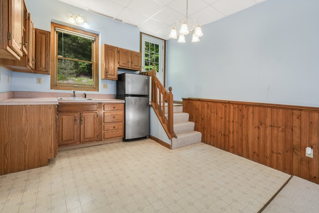 2020 Bay Road Stoughton, MA 02072 - Photo 32 of 38 a kitchen with stainless steel appliances granite countertop a refrigerator a sink dishwasher and wooden cabinets with wooden floor