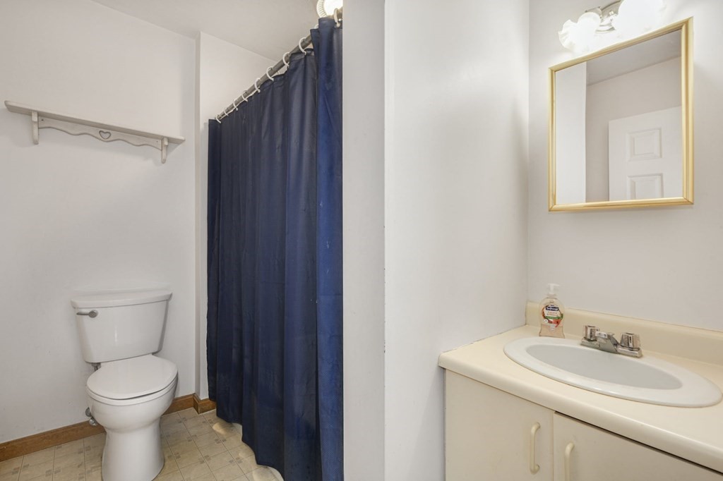 2020 Bay Road Stoughton, MA 02072 - Photo 33 of 38 a bathroom with a toilet a sink and mirror