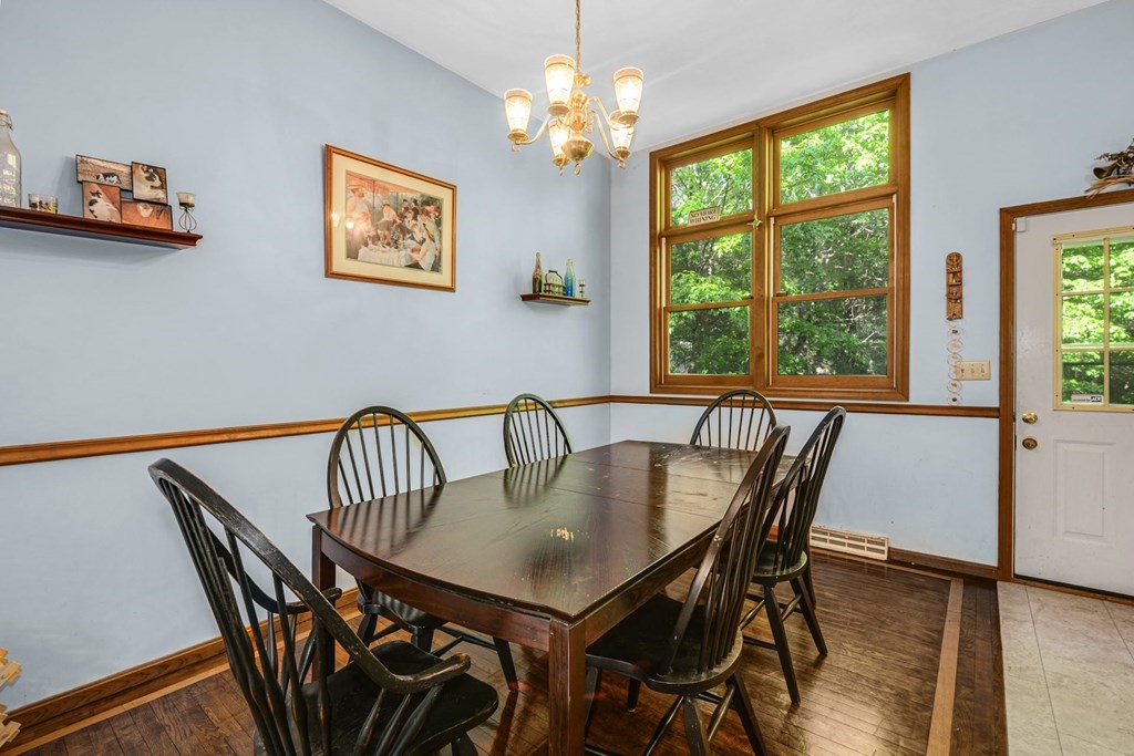 2020 Bay Road Stoughton, MA 02072 - Photo 9 of 38 a view of a dining room with furniture a chandelier and wooden floor