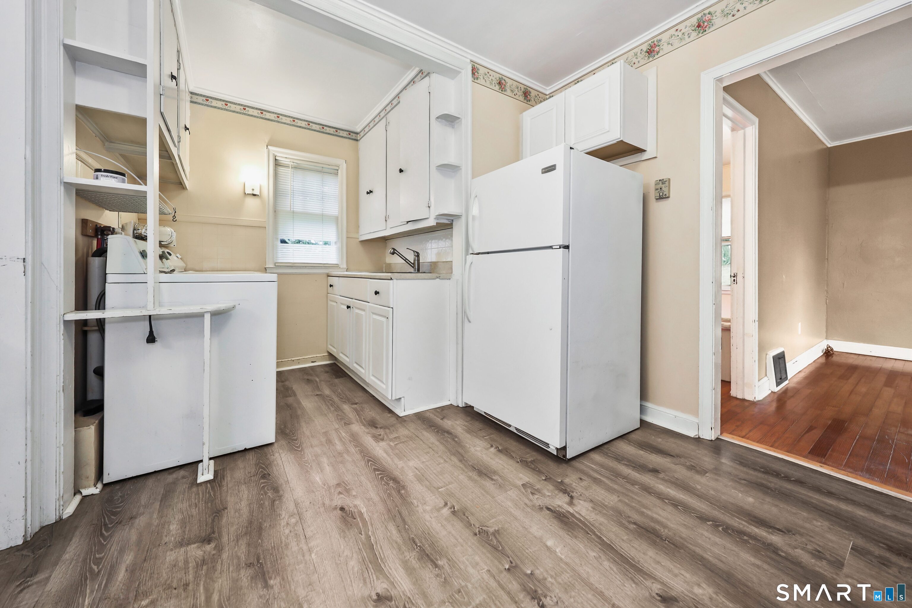 125 Tioga Street Torrington, CT 06790 - Photo 11 of 40 a kitchen with white cabinets and white appliances