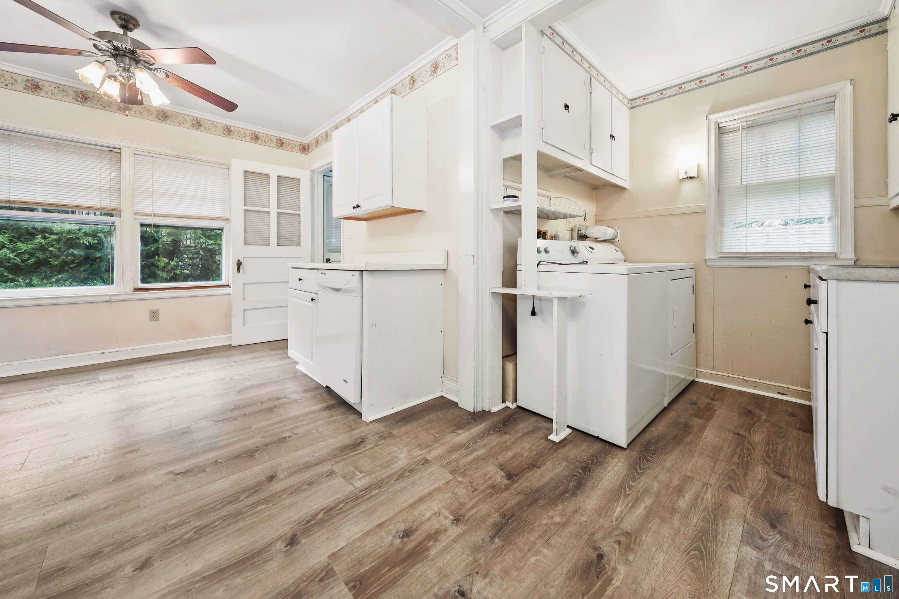 125 Tioga Street Torrington, CT 06790 - Photo 12 of 40 a kitchen with white cabinets and wooden floor