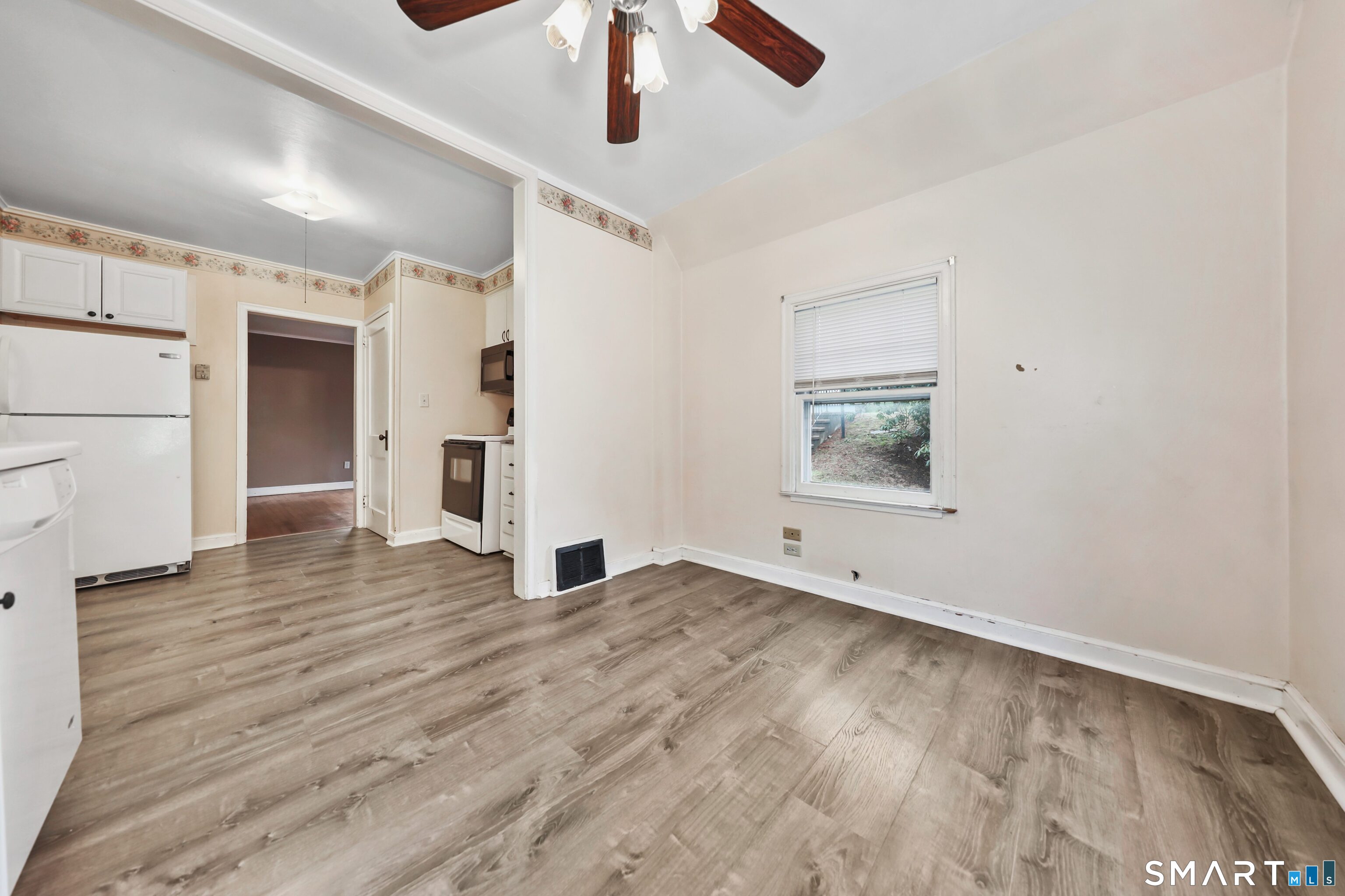 125 Tioga Street Torrington, CT 06790 - Photo 17 of 40 a view of empty room with wooden floor and ceiling fan