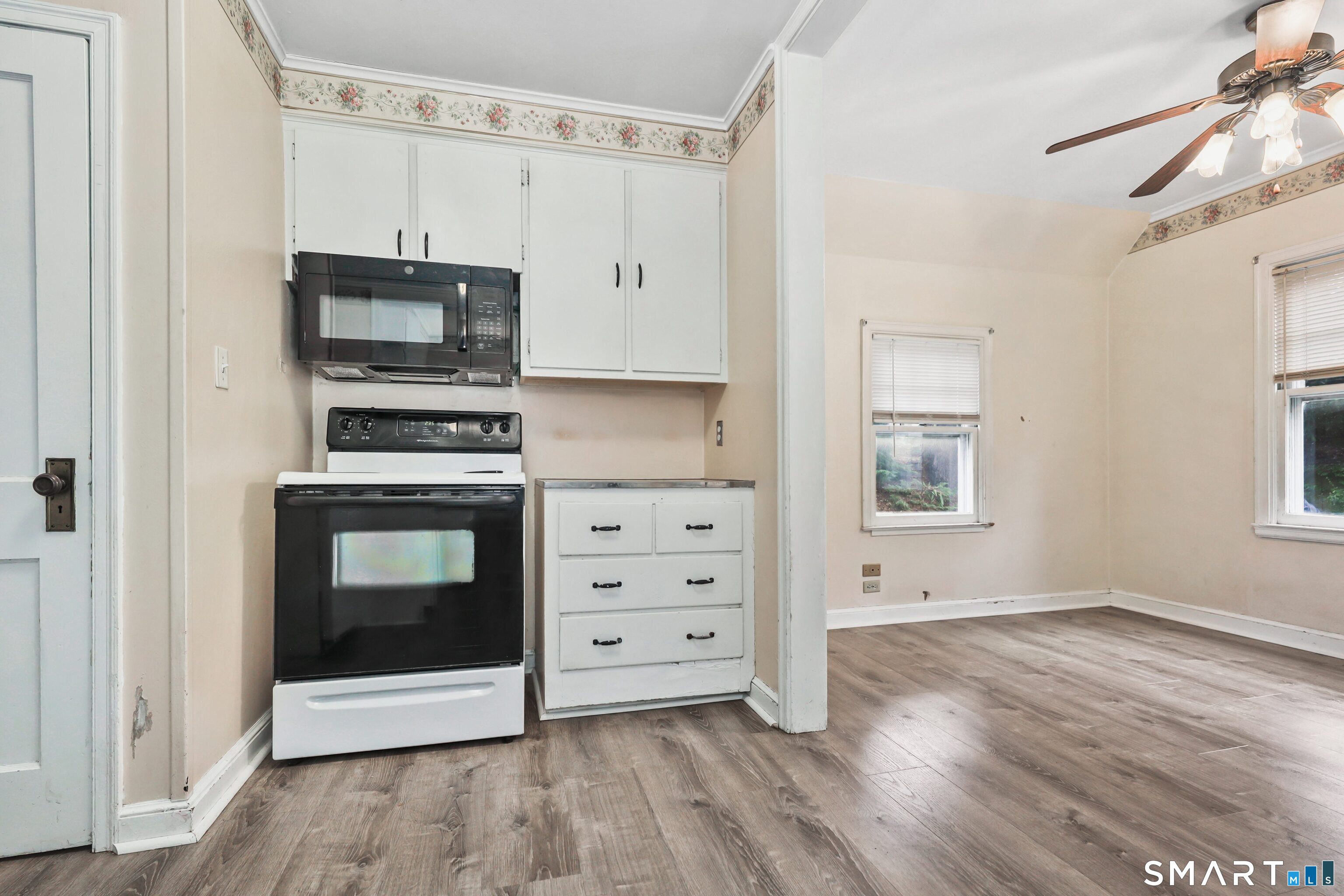125 Tioga Street Torrington, CT 06790 - Photo 19 of 40 a kitchen with stainless steel appliances a stove a microwave and sink
