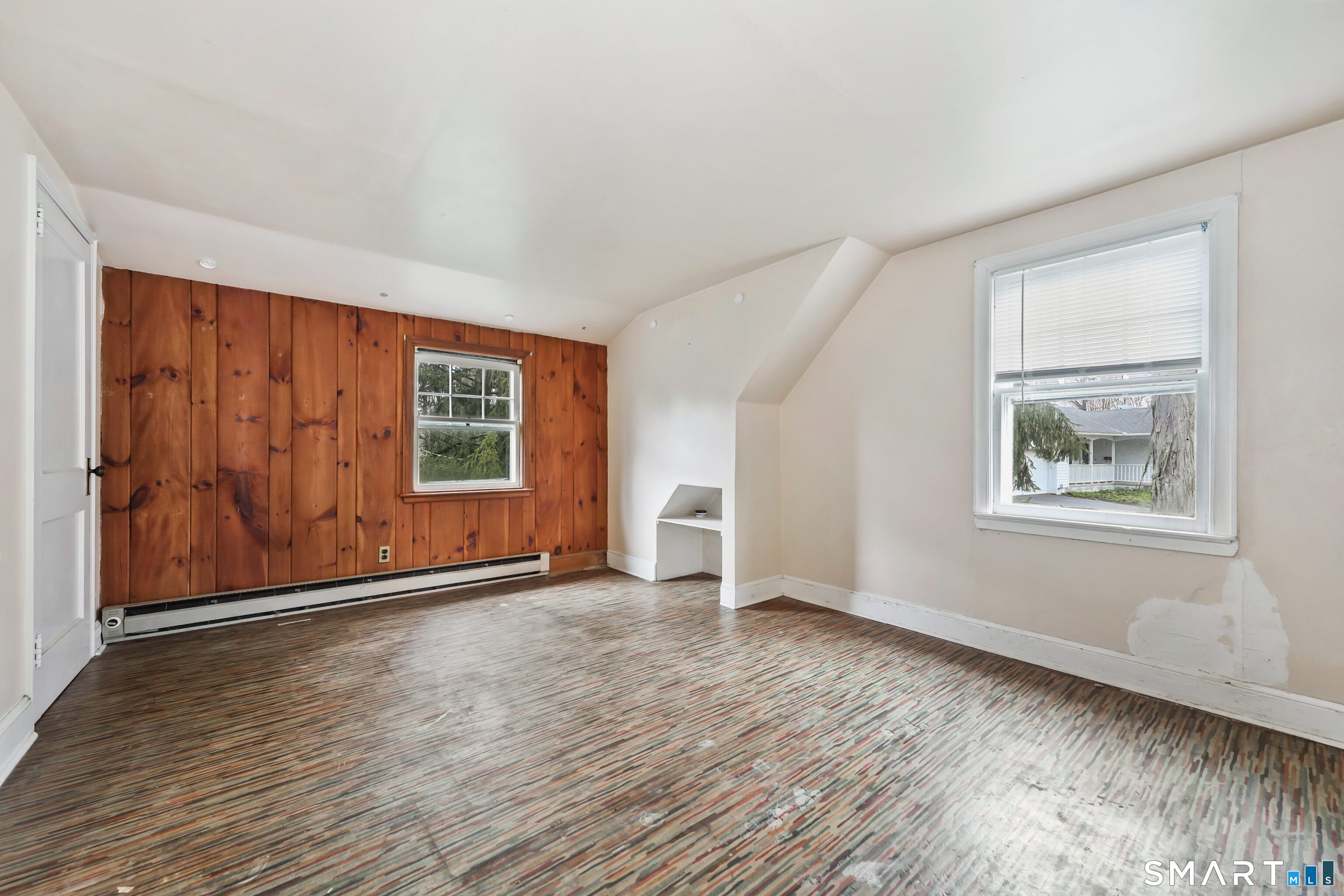 125 Tioga Street Torrington, CT 06790 - Photo 22 of 40 an empty room with wooden floor and windows