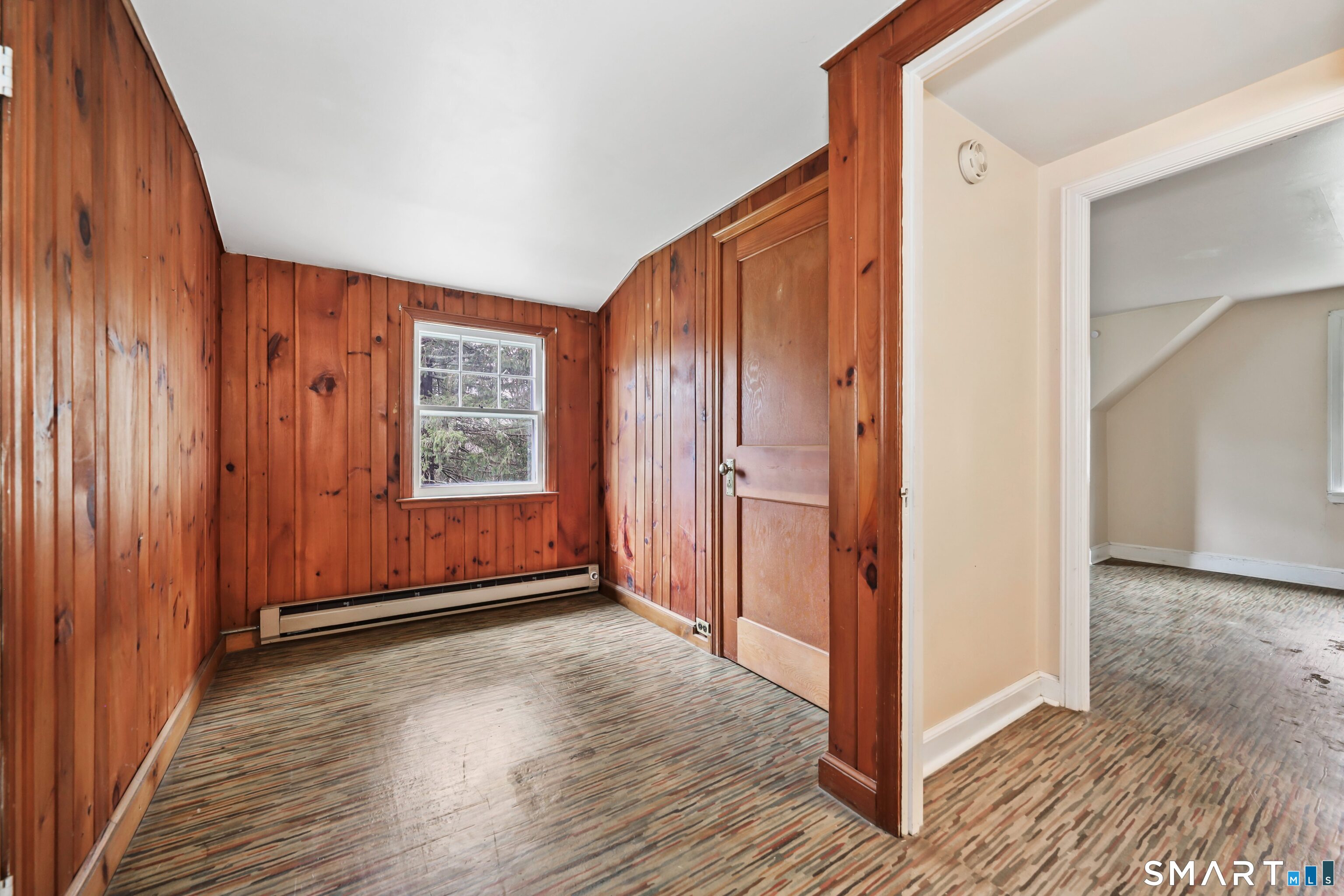 125 Tioga Street Torrington, CT 06790 - Photo 23 of 40 an empty room with wooden floor and windows