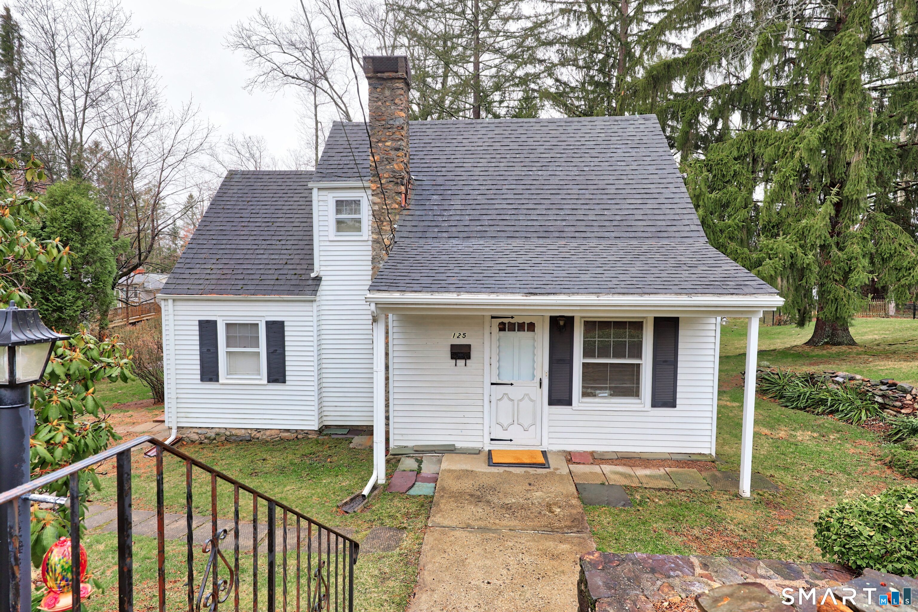 125 Tioga Street Torrington, CT 06790 - Photo 3 of 40 a front view of house with yard and trees in the background