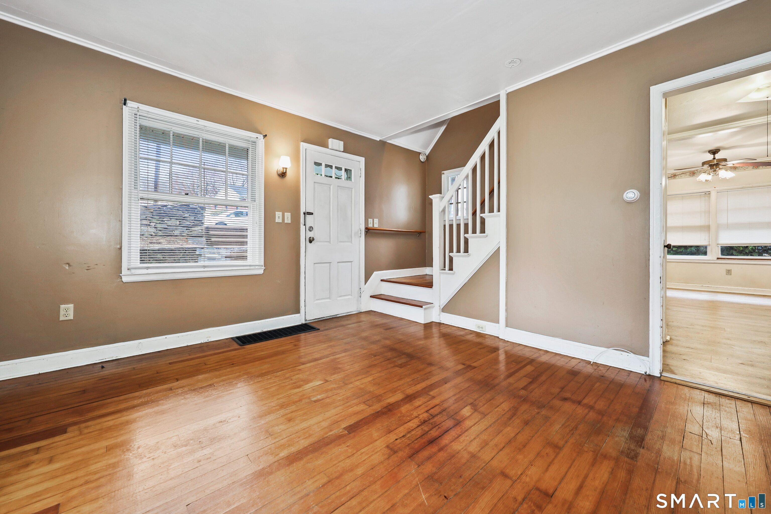 125 Tioga Street Torrington, CT 06790 - Photo 5 of 40 a view of an empty room with wooden floor and a window