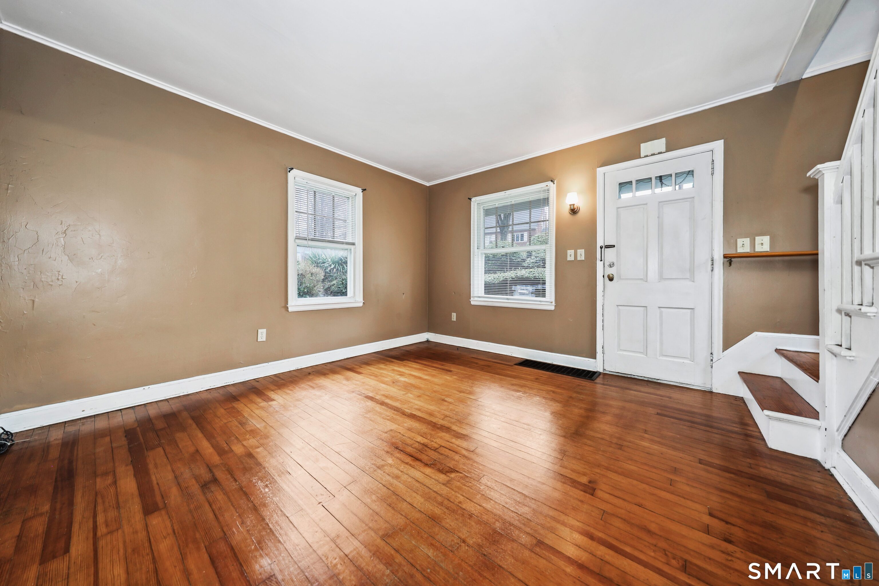 125 Tioga Street Torrington, CT 06790 - Photo 6 of 40 a view of an empty room with a window and wooden floor
