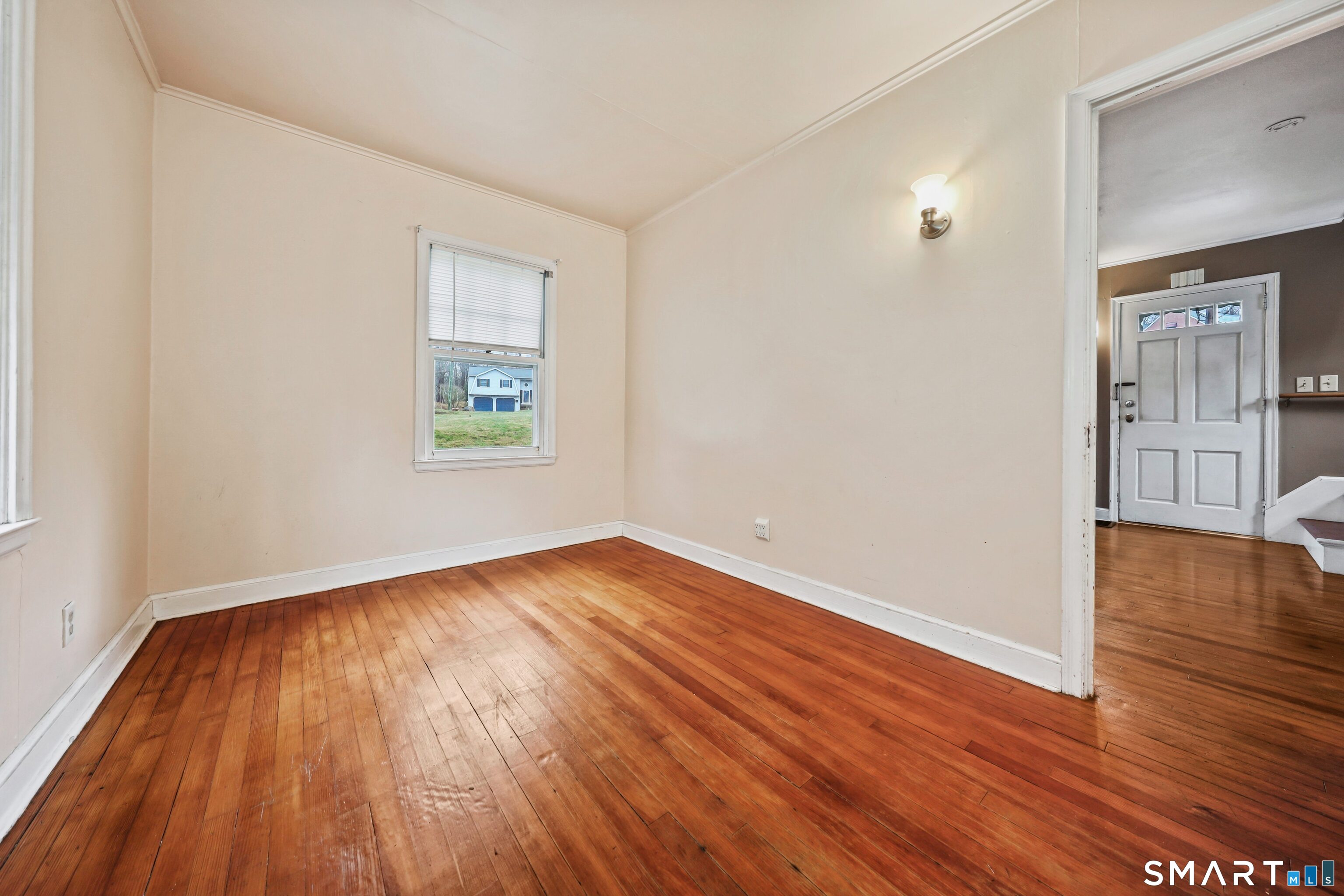 125 Tioga Street Torrington, CT 06790 - Photo 7 of 40 an empty room with wooden floor and windows