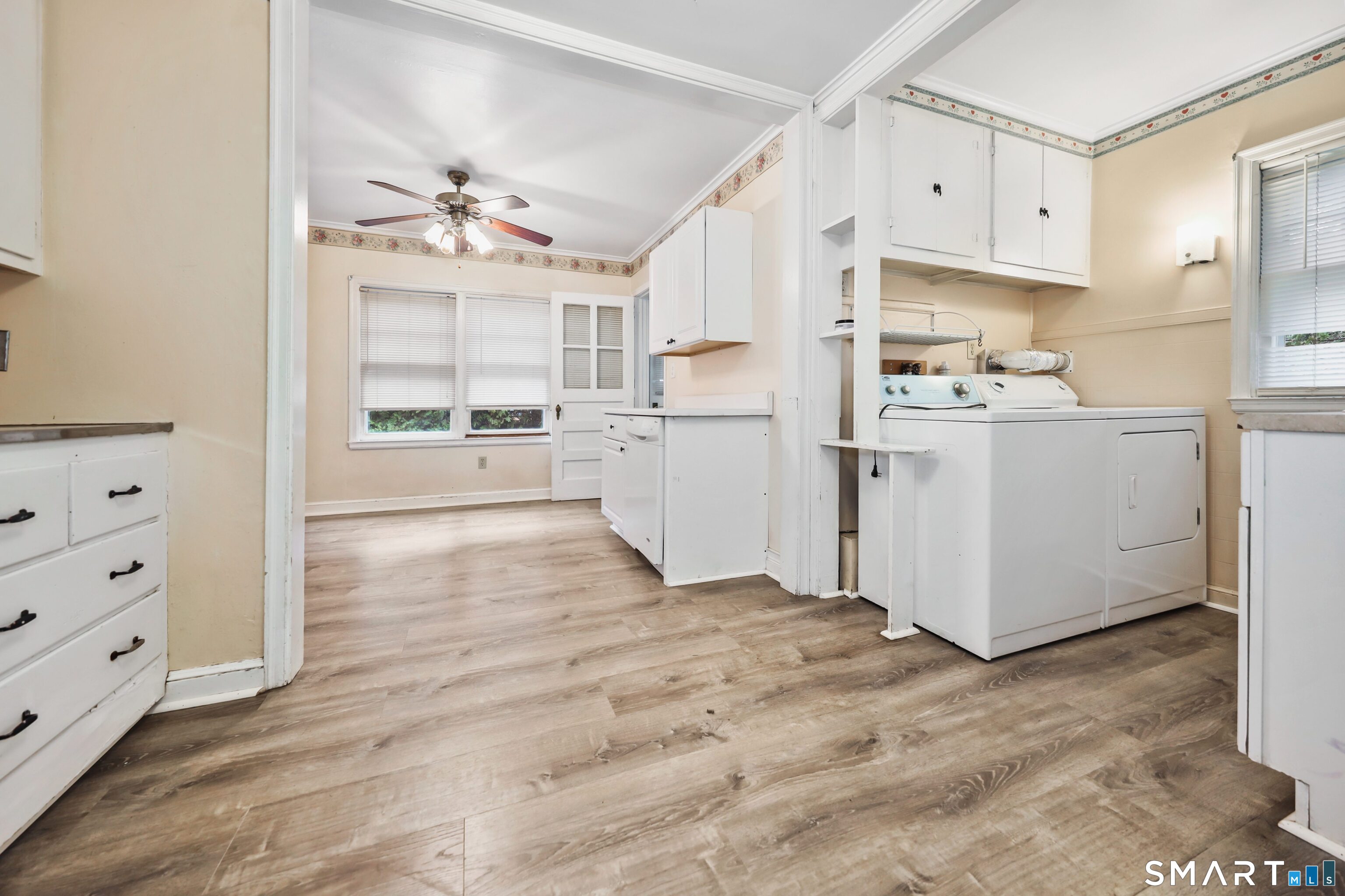 125 Tioga Street Torrington, CT 06790 - Photo 9 of 40 a kitchen with cabinets and wooden floor