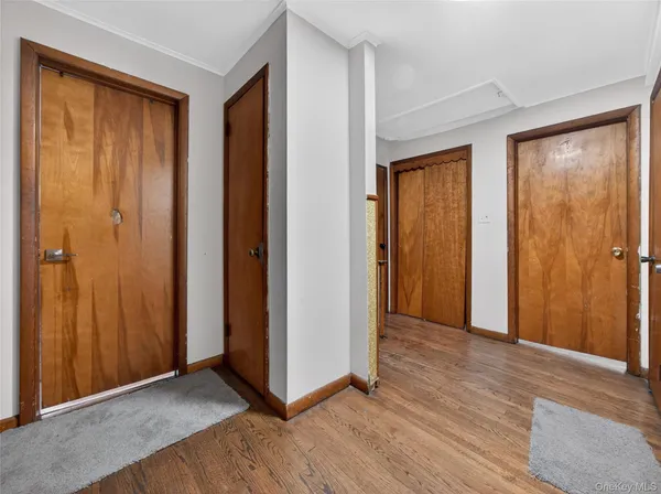 an empty room with wooden floor and closet