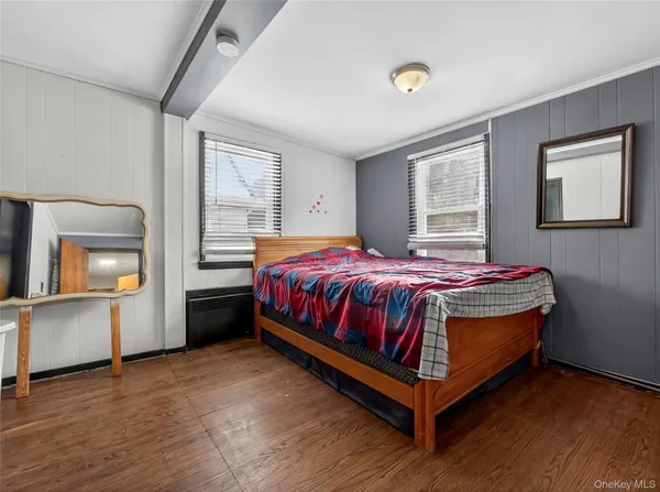 a bed sitting in a bedroom next to a window