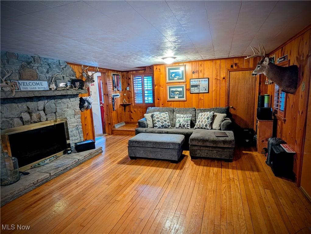 544 Maple Lake Road Bridgeport, WV 26330 - Photo 9 of 20 Living room with light wood-type flooring, a fireplace, and wooden walls