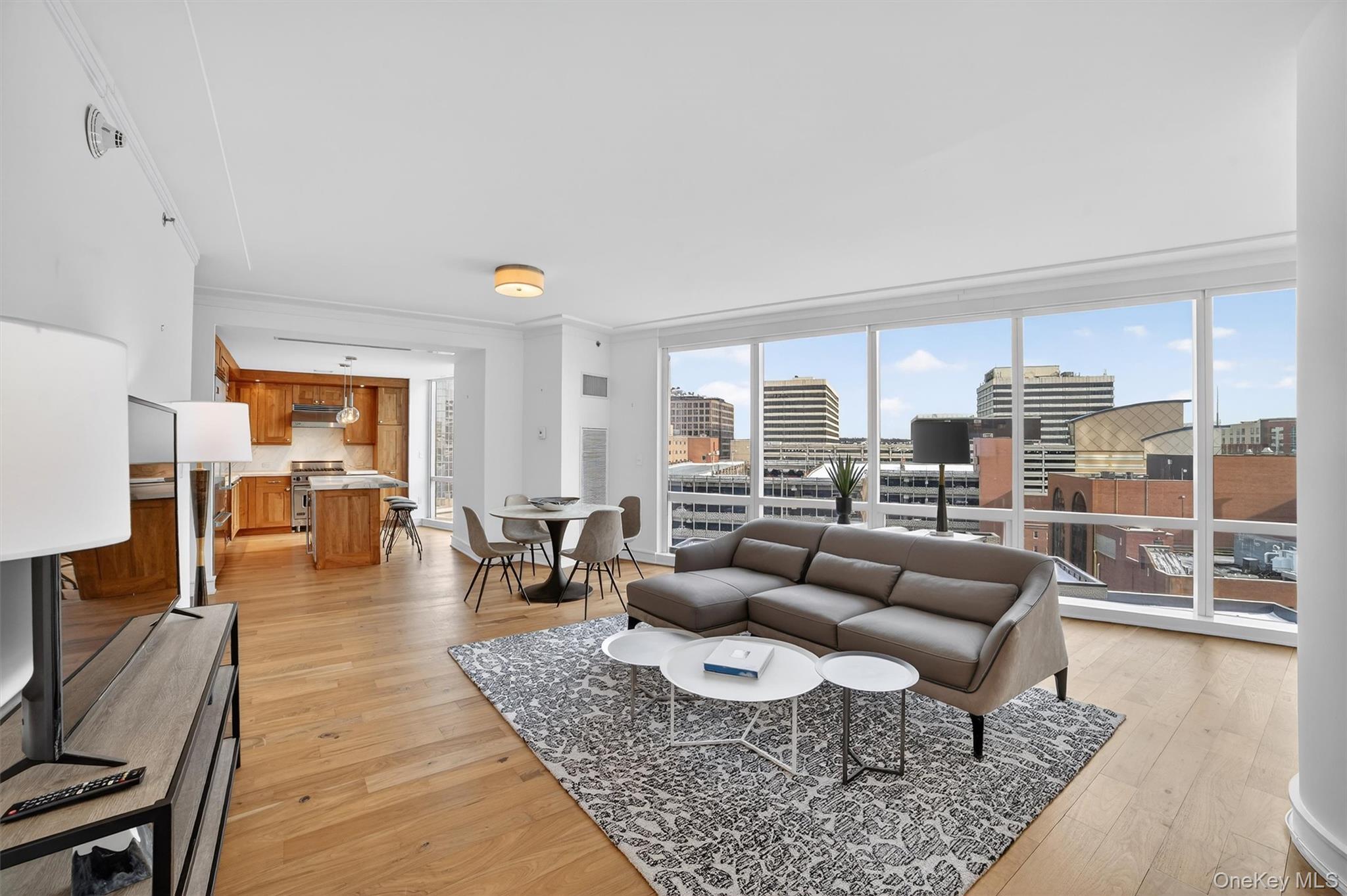 5 Renaissance Square, Unit 10G White Plains, NY 10601 - Photo 1 of 27 a living room with furniture and a large window