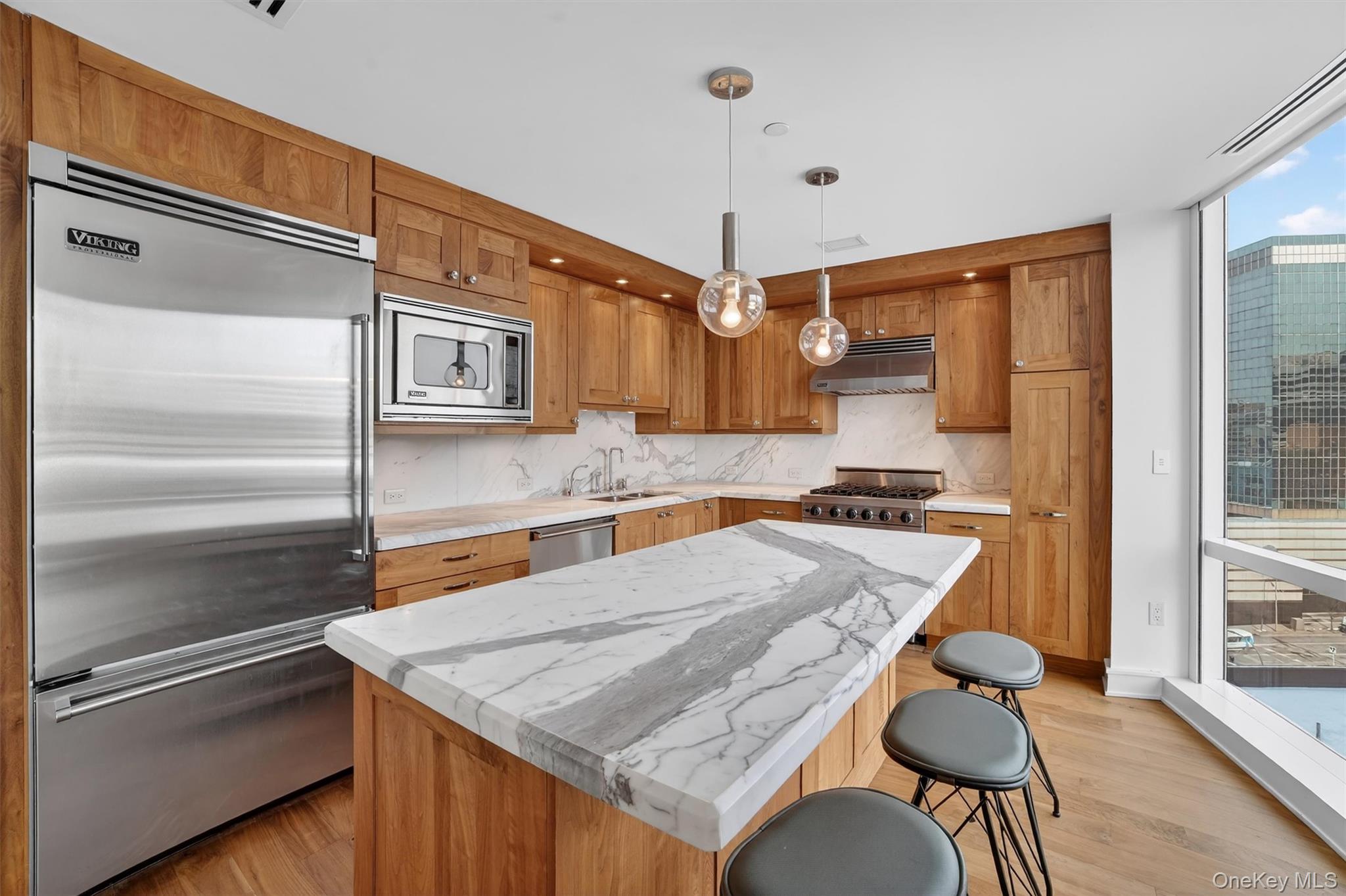 5 Renaissance Square, Unit 10G White Plains, NY 10601 - Photo 11 of 27 a kitchen with a table and chairs