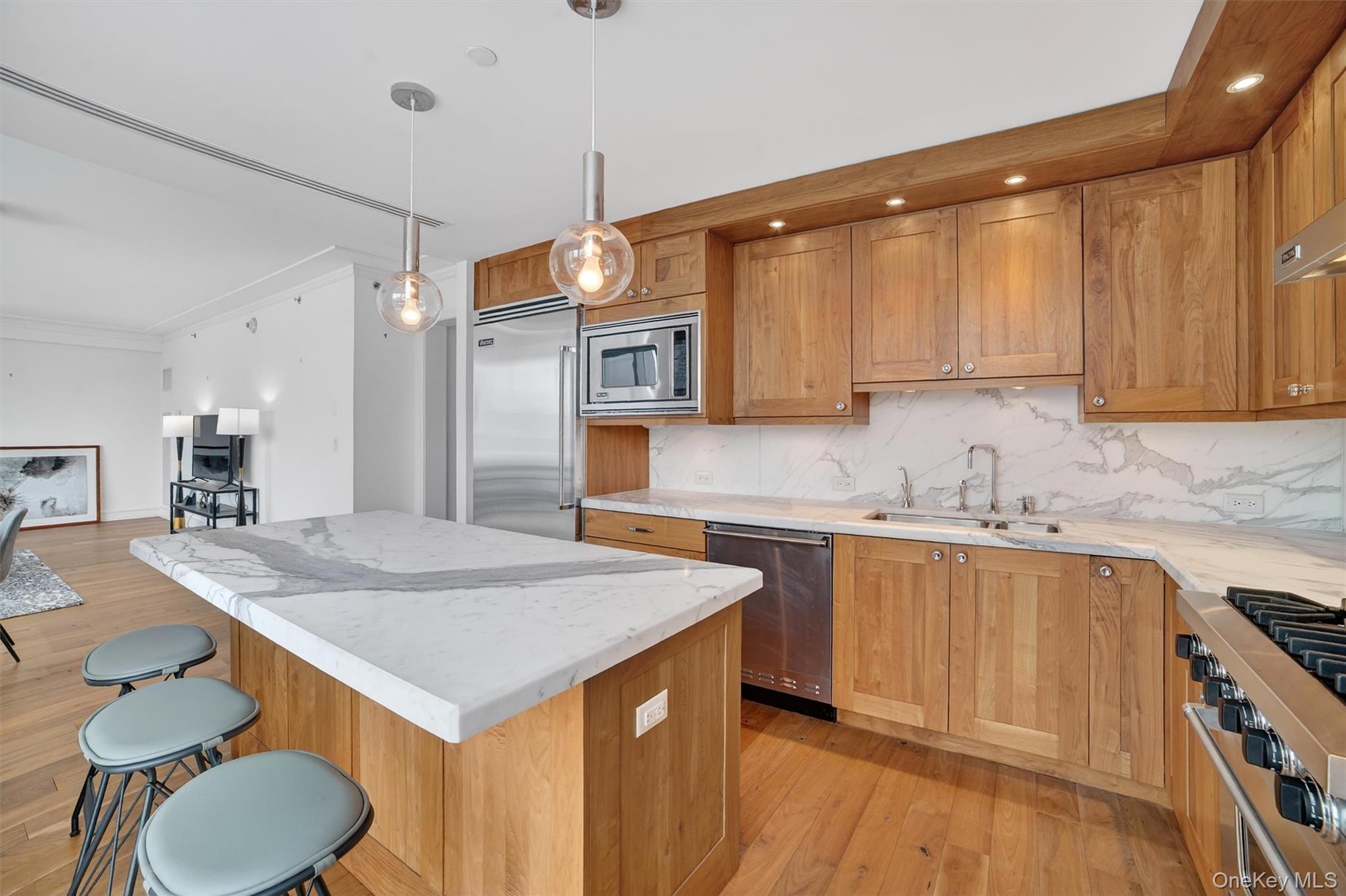 5 Renaissance Square, Unit 10G White Plains, NY 10601 - Photo 12 of 27 a kitchen with a sink a stove and chairs
