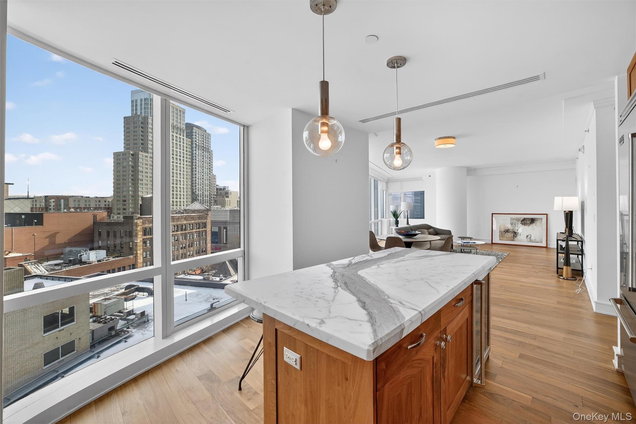 5 Renaissance Square, Unit 10G White Plains, NY 10601 - Photo 13 of 27 a kitchen with a stove a sink and a wooden floors