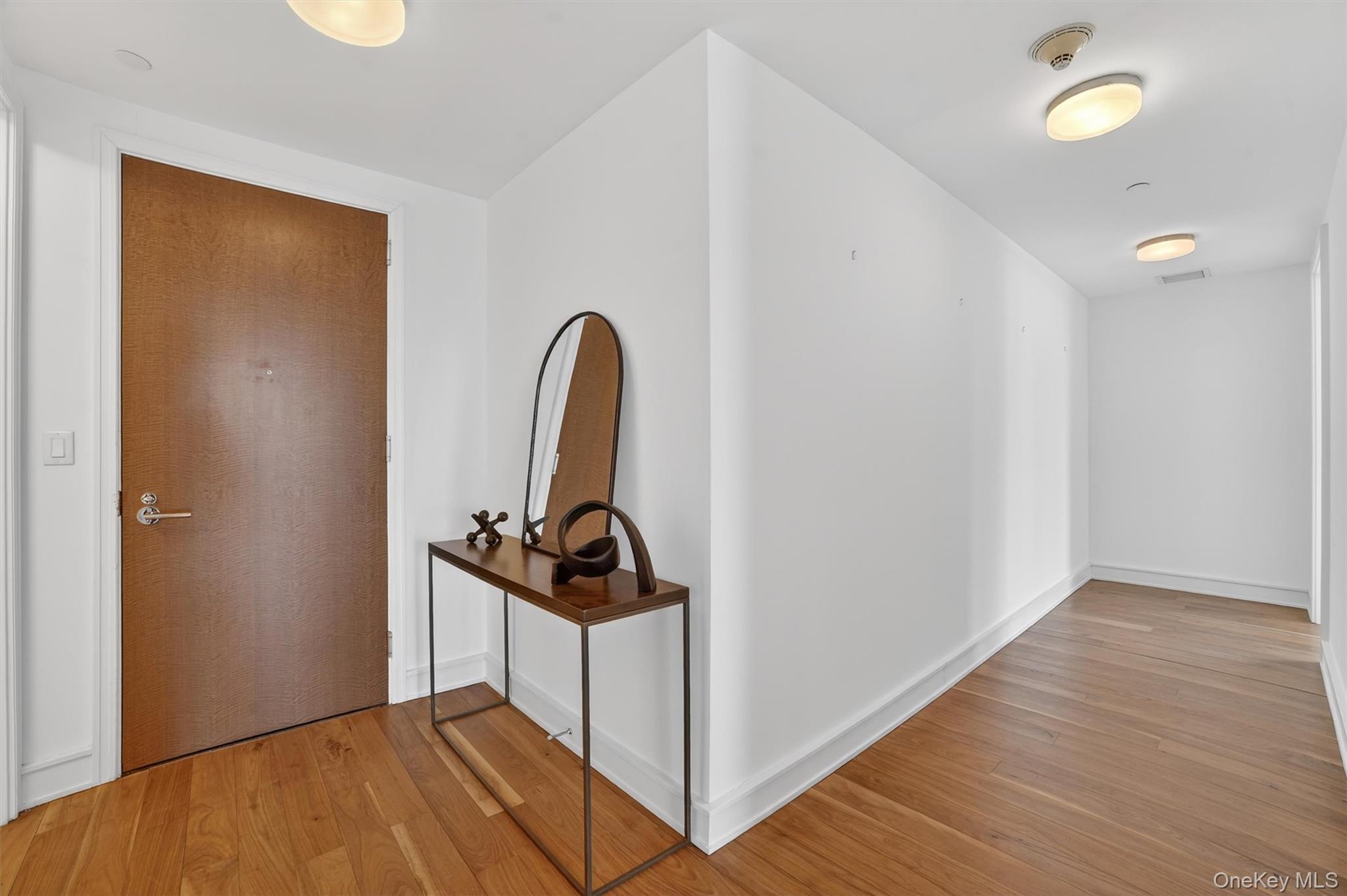 5 Renaissance Square, Unit 10G White Plains, NY 10601 - Photo 2 of 27 a view of a room with wooden floor and bathroom