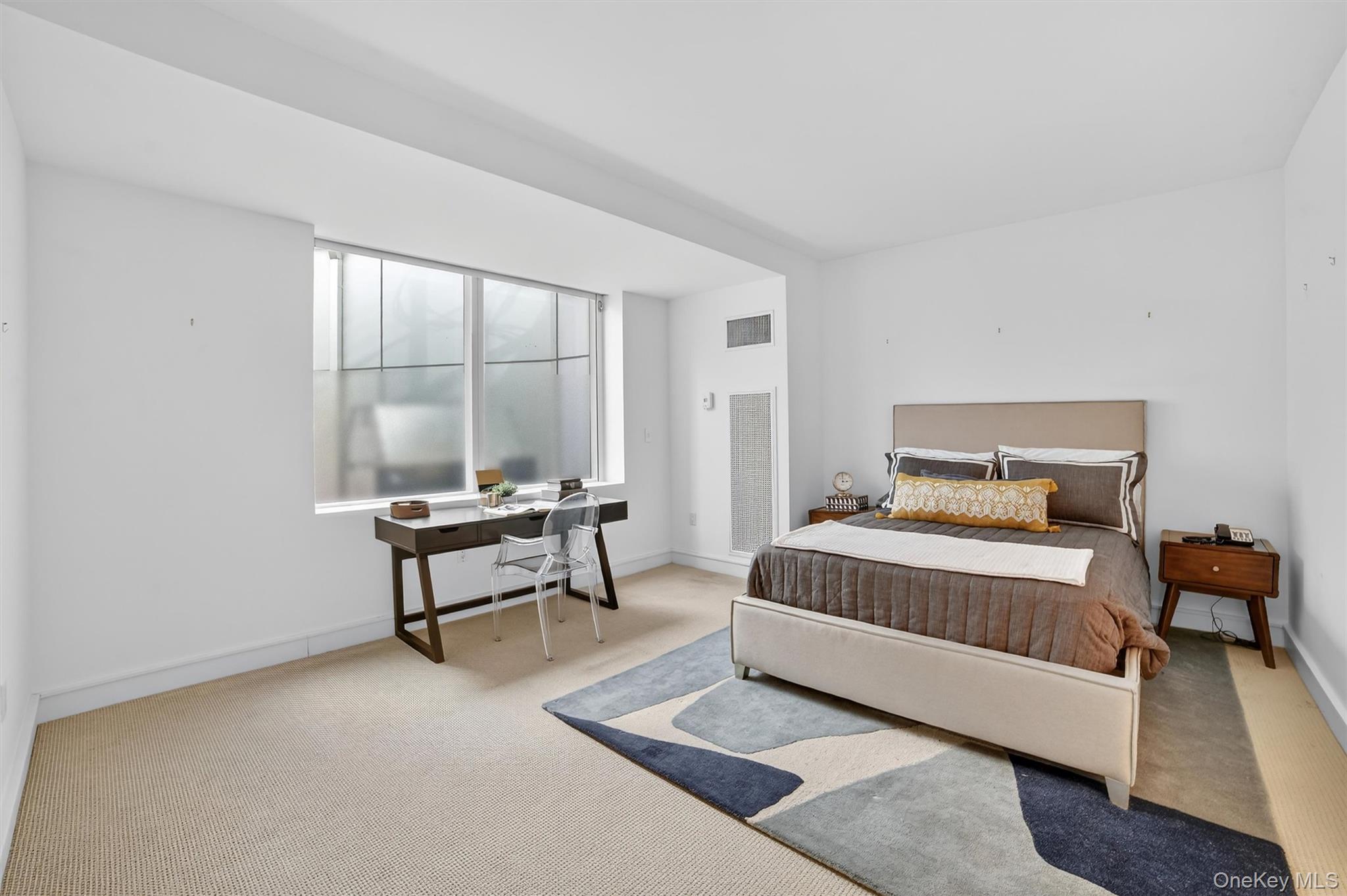 5 Renaissance Square, Unit 10G White Plains, NY 10601 - Photo 23 of 27 a bedroom with a bed and a window